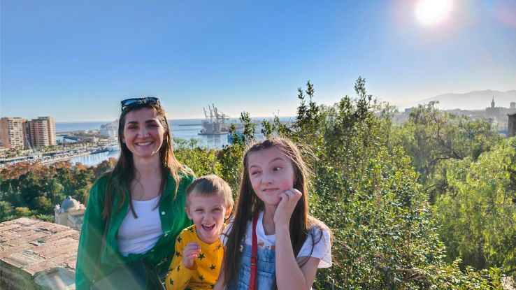 family adventure as a mother, son, and daughter share joyous moments during a sunny day in Spain